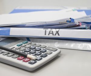 Folder Tax documents and paper files with calculator concept Annual tax payment
